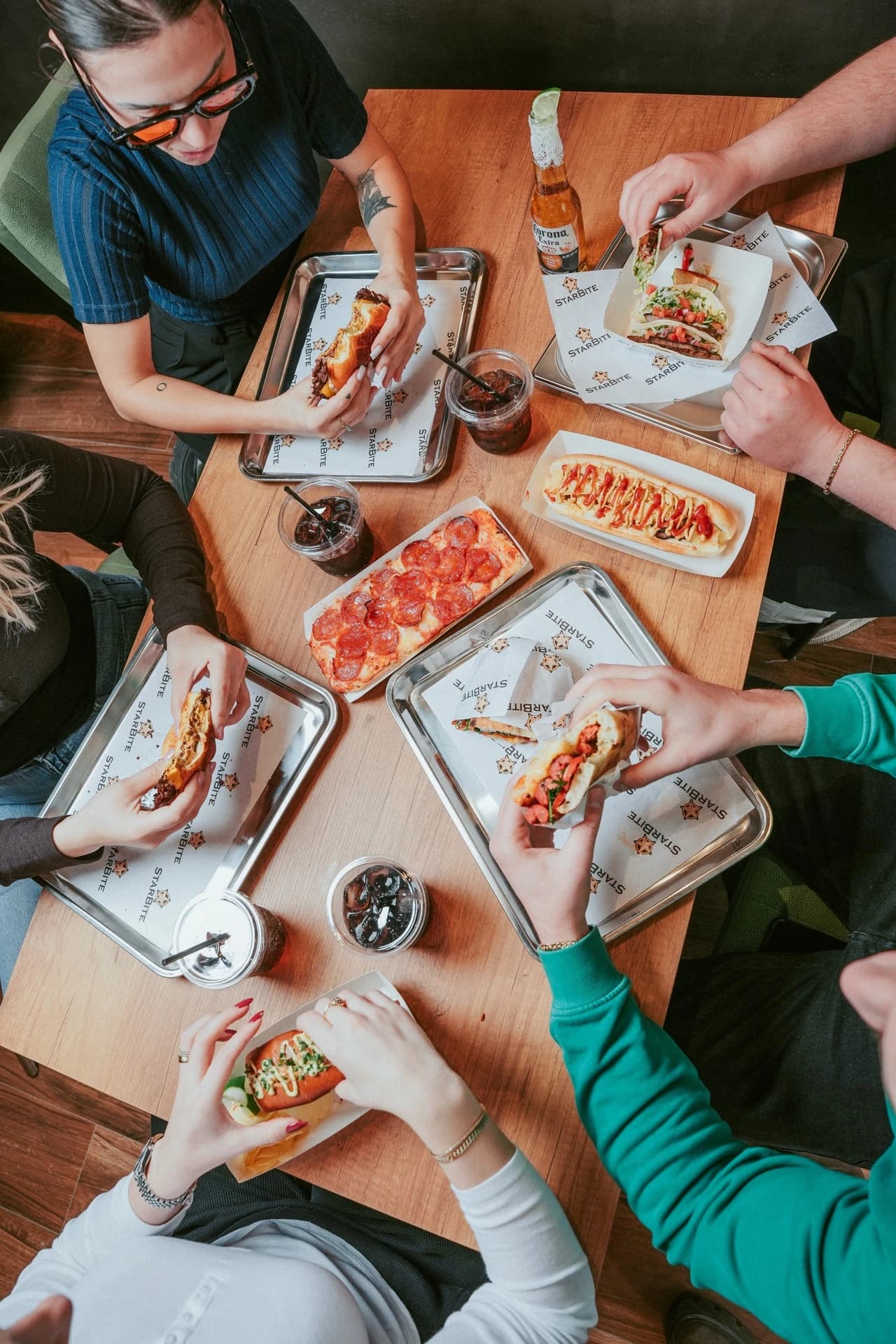 Friends sharing food around a full table