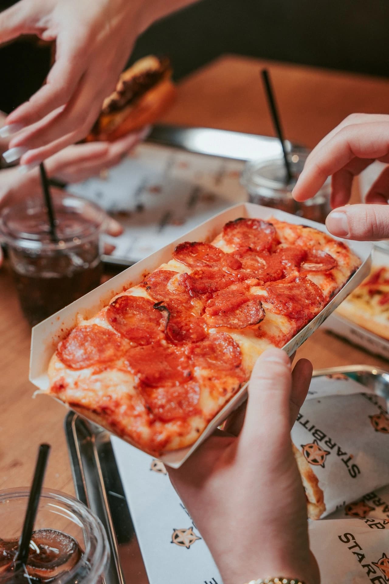 Pepperoni pizza slice held up close